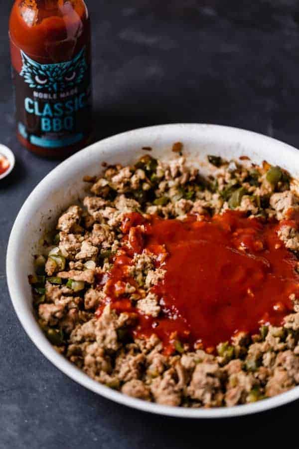 cooked ground turkey in a white bowl with classic BBQ on top