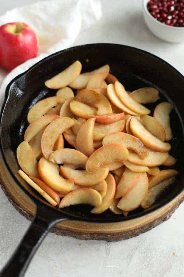 Overhead view of sliced apples in a skillet