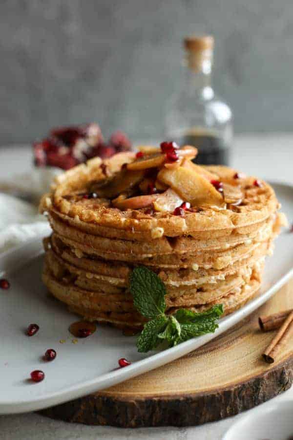 Close up view of waffles stacked on a white plate