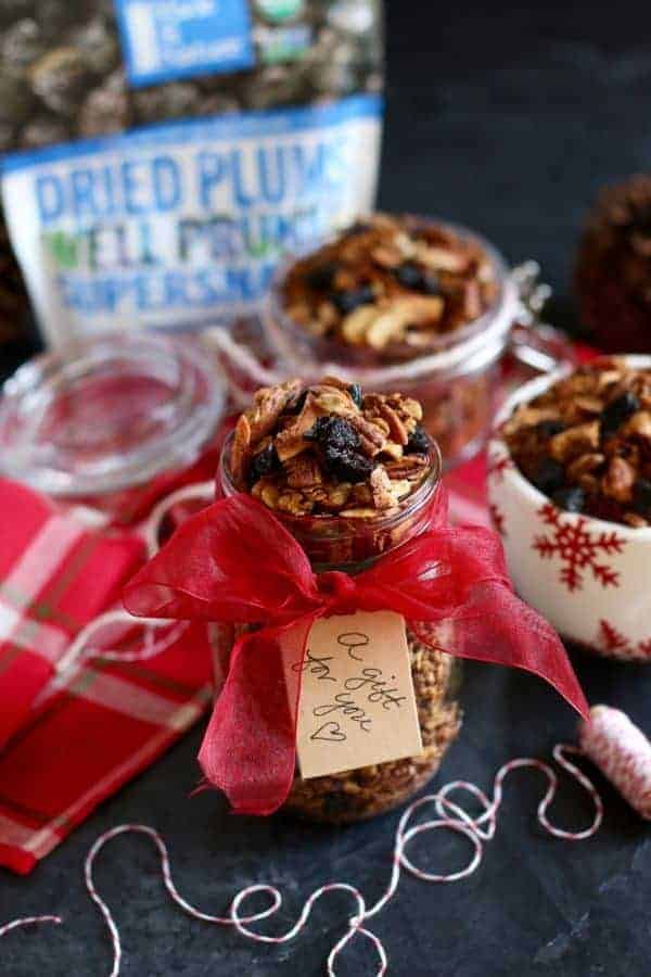 Vanilla Chai Spiced Granola in a mason jar wrapped with a red ribbon and a tag on it that says "gift for you". 