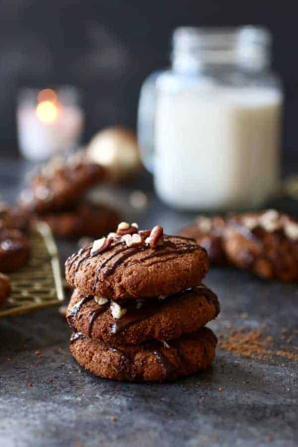 Paleo Soft Batch Ginger Molasses Cookies stacked into a pile of three cookies on a counter top