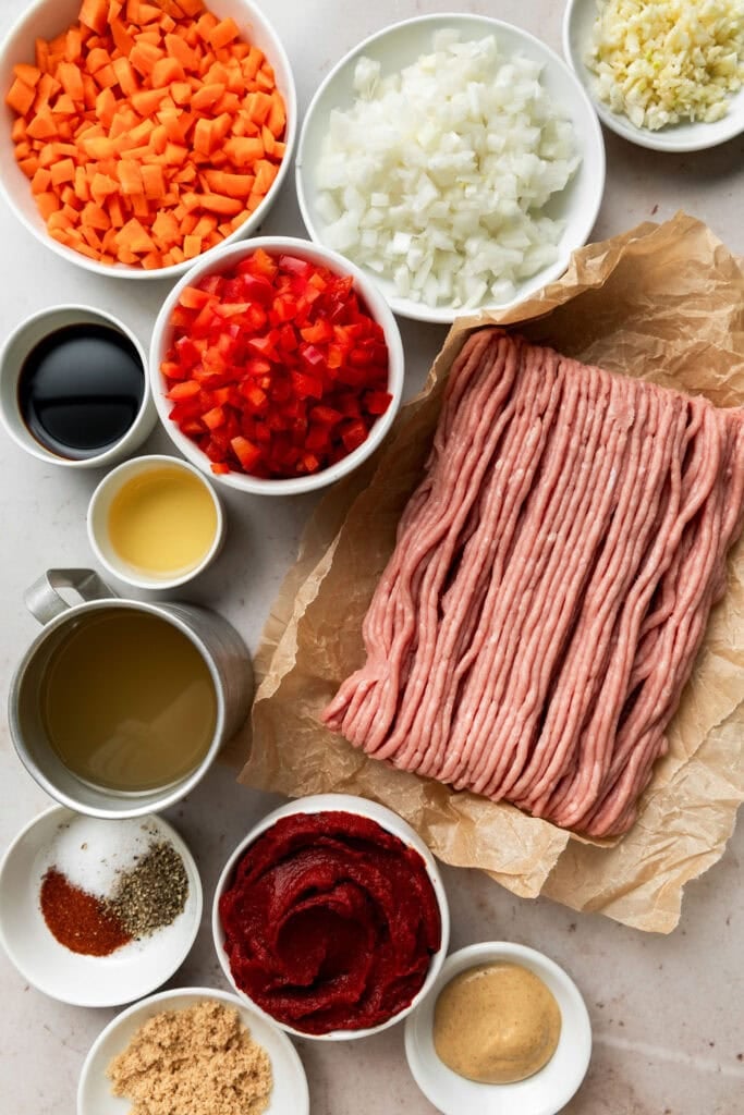 Overhead view of a variety of ingredients for ground turkey sloppy joes. 