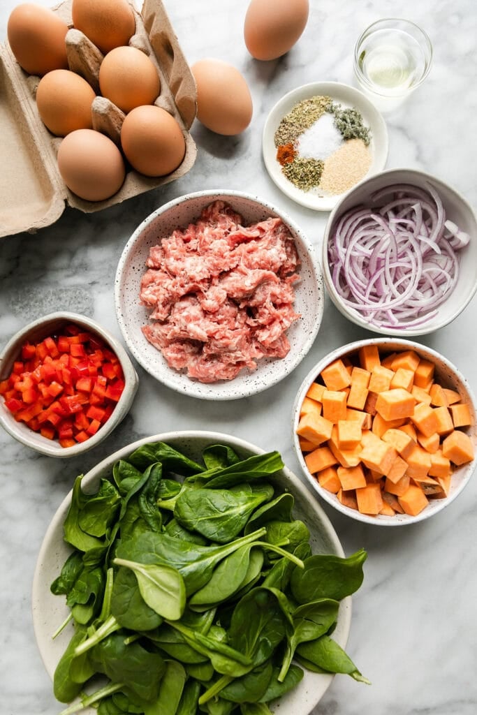 All ingredients for sweet potato breakfast casserole arranged in small bowls.