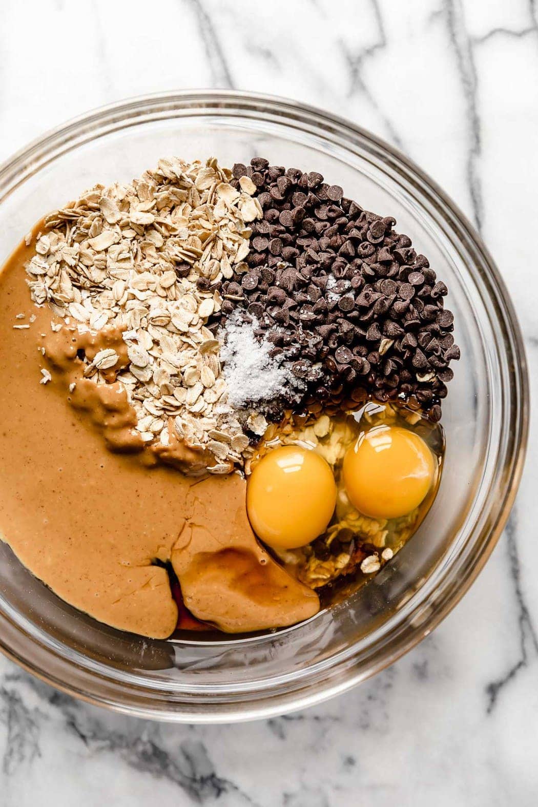 Ingredients for healthy granola bars in a mixing bowl ready for mixing together