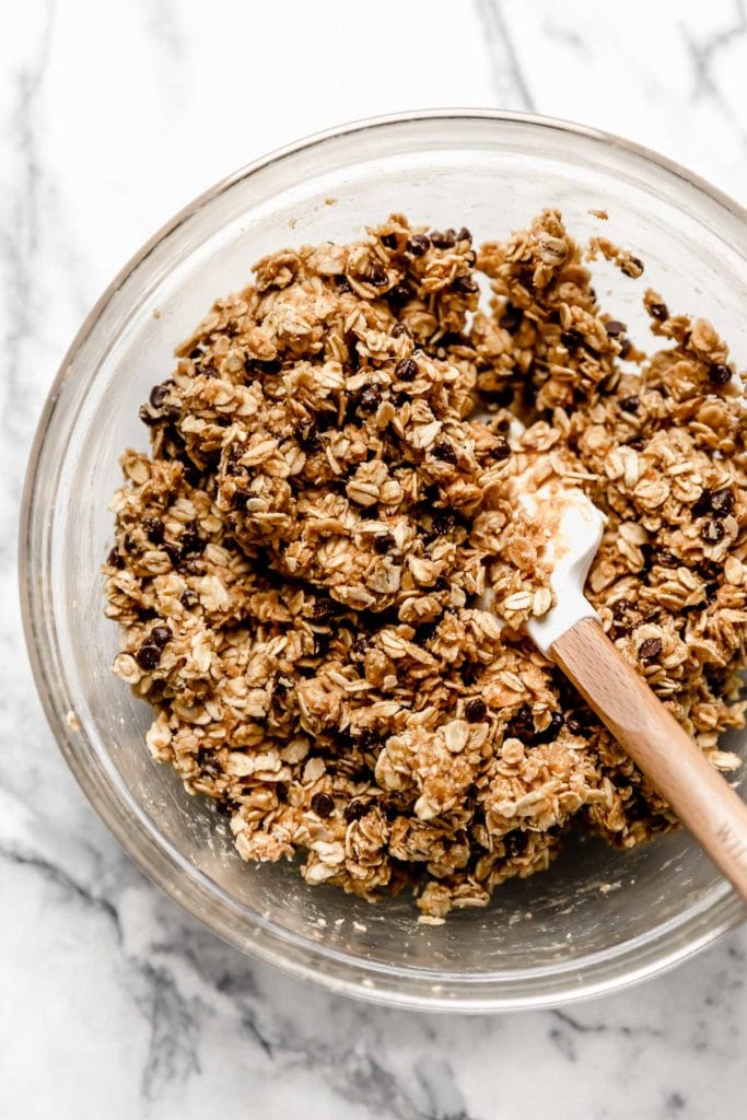 Healthy peanut butter chocolate chip granola bar mixture freshly stirred in a mixing bowl