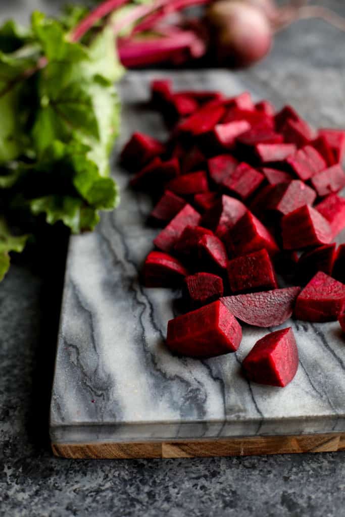 Beets diced up on marble cutting board