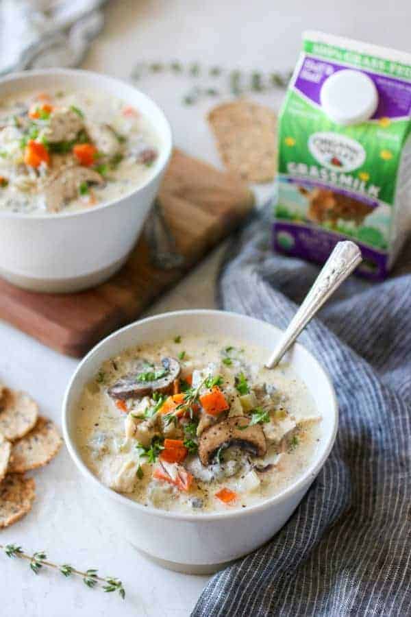 Photo of two white bowls of Slow Cooker Creamy Chicken Wild Rice Soup.