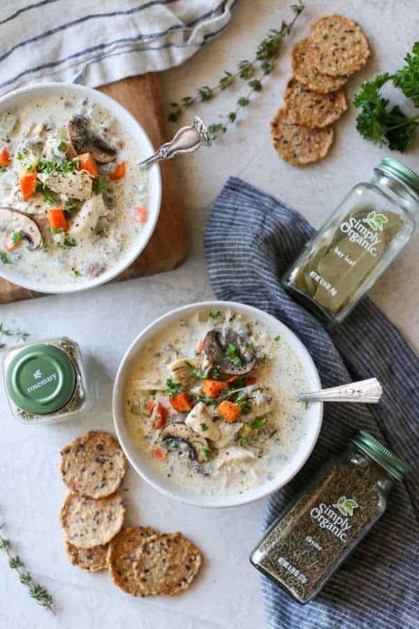Overhead photo of two white bowls of Slow Cooker Creamy Chicken Wild Rice Soup.