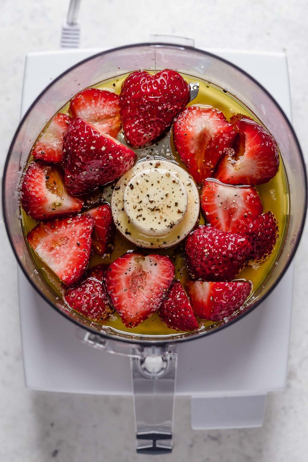 Ingredients for strawberry vinaigrette in food processor.