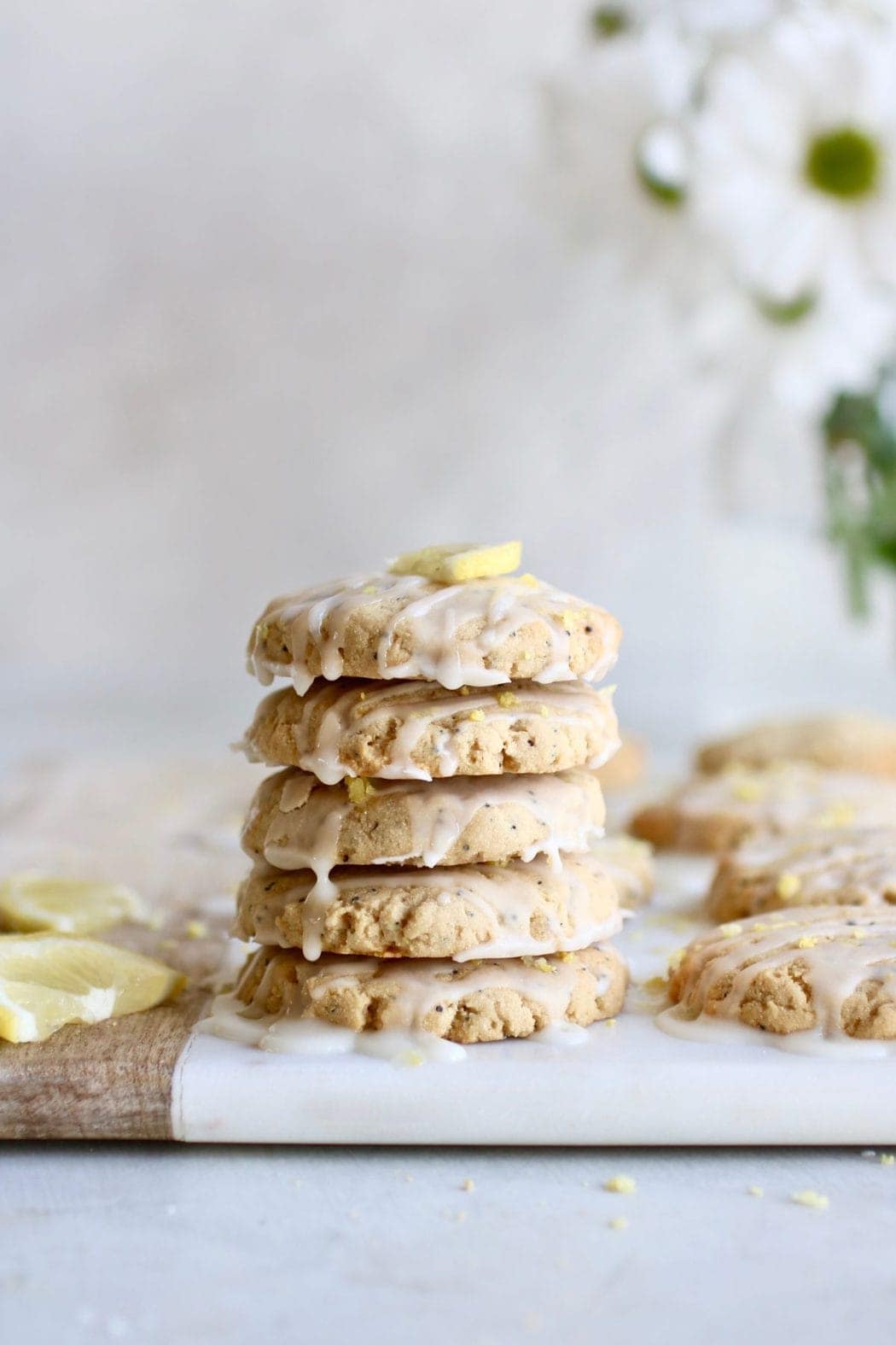 Photo of a stack of five Paleo Lemon Poppy Seed Cookies drizzled with a glaze.