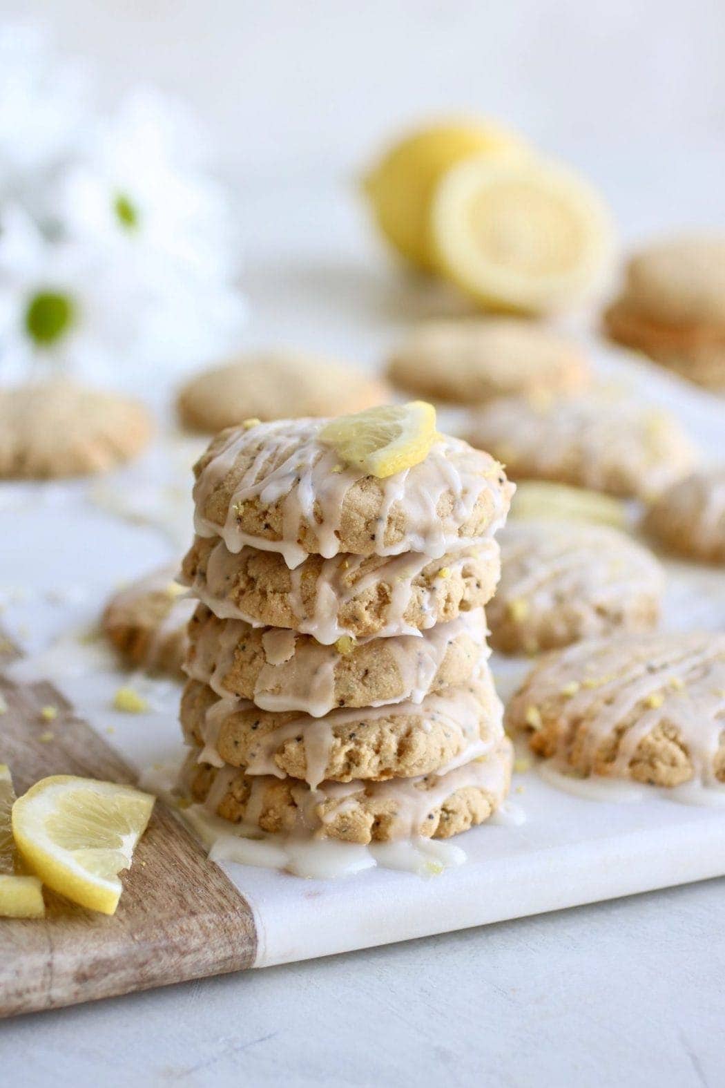 Photo of a stack of five Paleo Lemon Poppy Seed Cookies drizzled with a glaze.