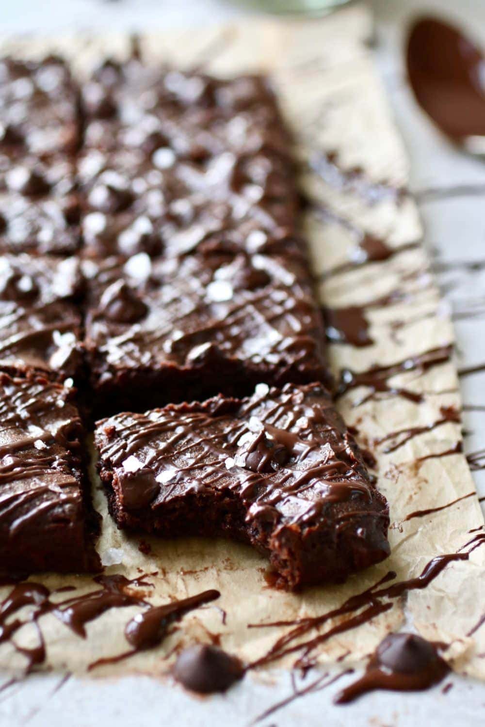 Close up photo of the Paleo Fudgy Brownies with a bite out of the brownie in the front.