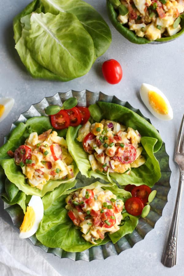 Three BLT egg salad lettuce wraps on a metal tray