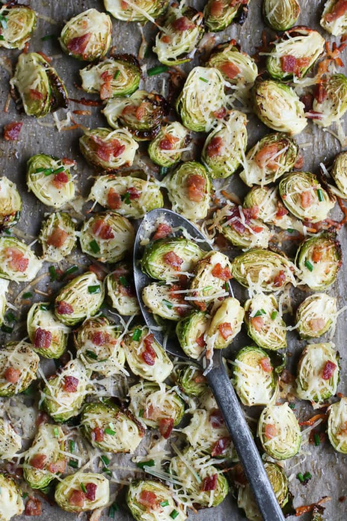 See the top of Brussels roasted Parmesan with pork on a parchment-covered baking sheet.