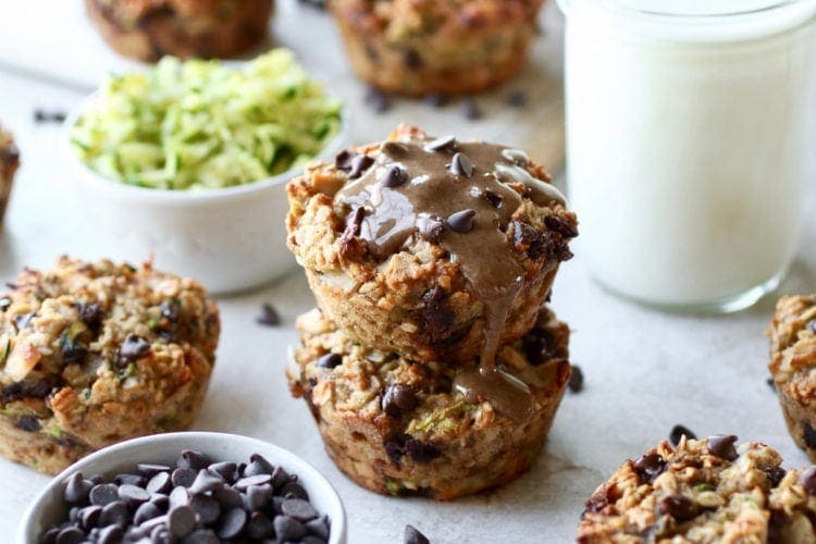 Two zucchini oatmeal breakfast muffins stacked on top of each other as part of 6 freezer breakfast recipes