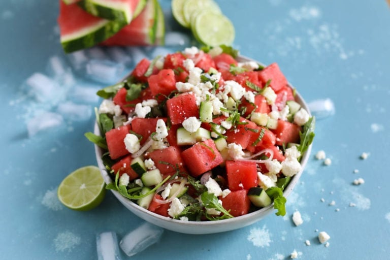 watermelon cucumber salad in serving bowl topped with feta cheese