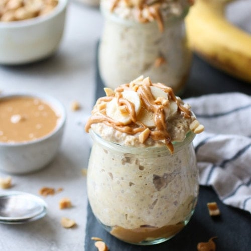 Peanut Butter Banana Overnight Oats in a small glass jar topped with banana slices and peanut butter drizzle
