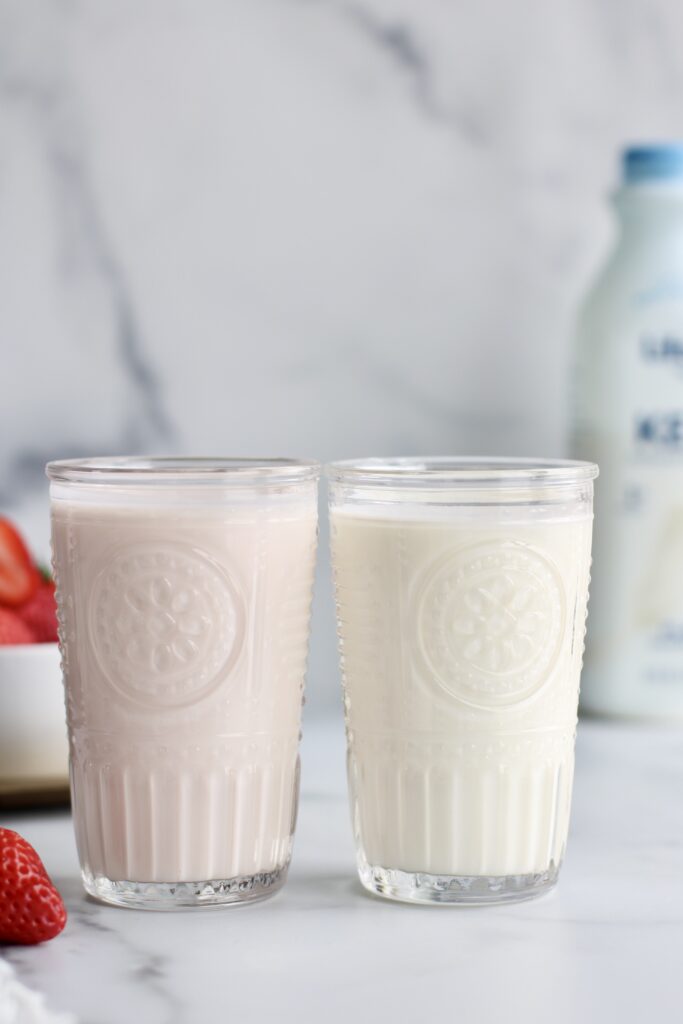Side view of 2 glasses filled with Kefir. 