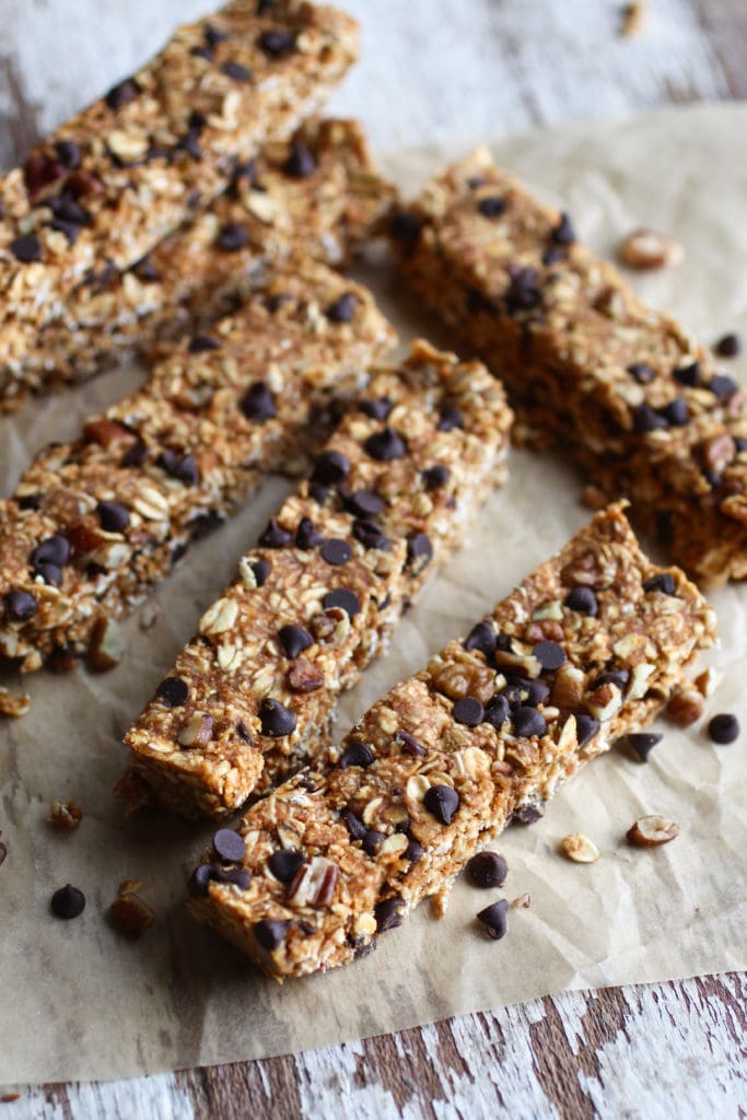 Six chocolate-chip filled oat granola bars on parchment paper