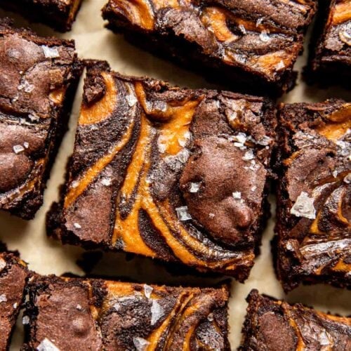 Pumpkin Brownies with pumpkin cream cheese swirled middle layer, cut into bars