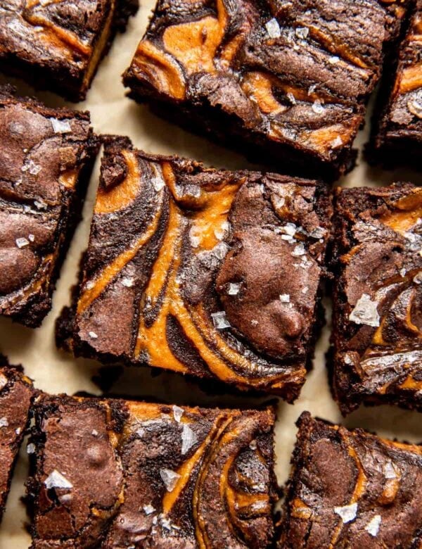 Pumpkin Brownies with pumpkin cream cheese swirled middle layer, cut into bars