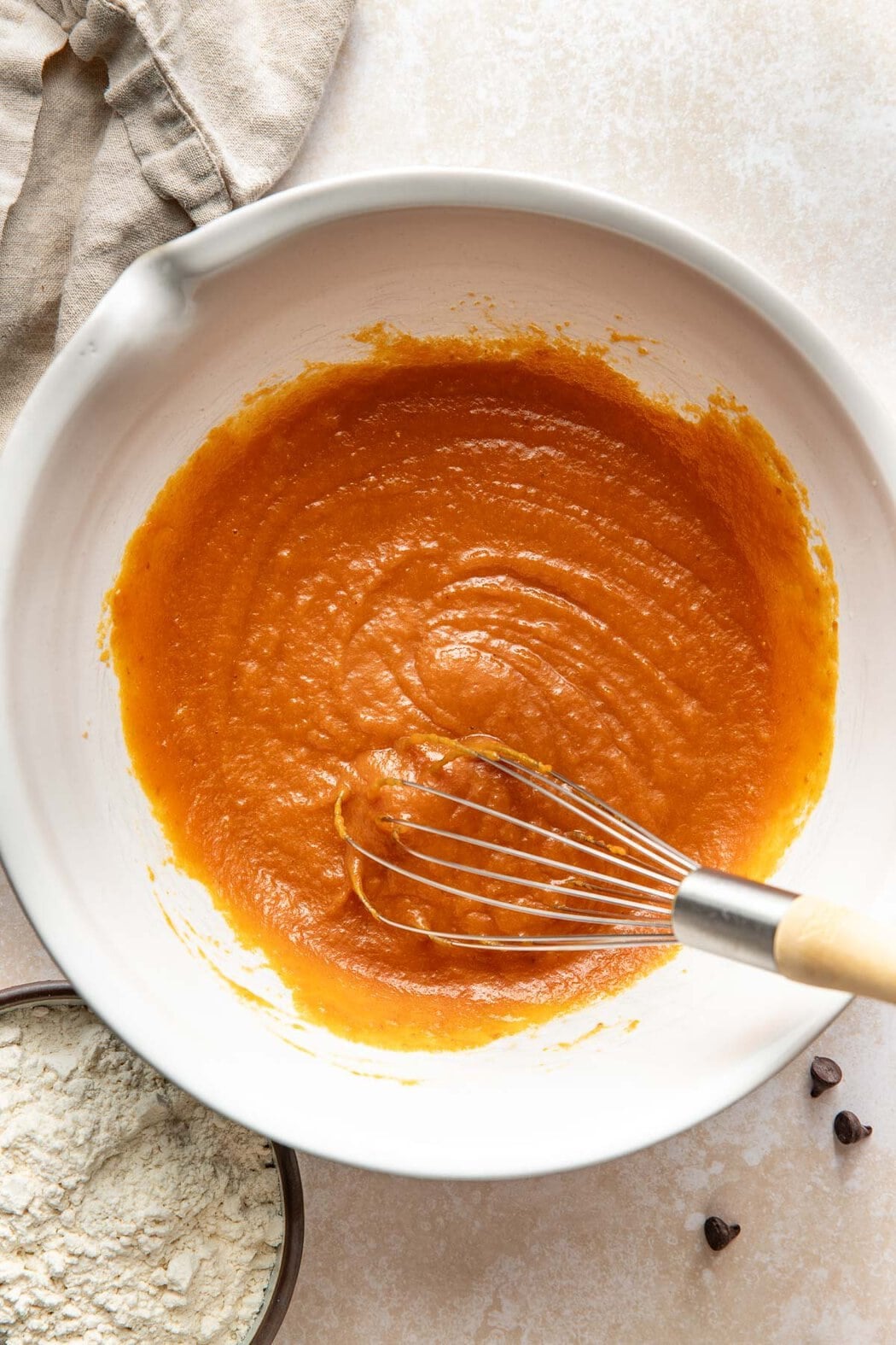 Mixed wet ingredients for pumpkin chocolate chip bars in a bowl.