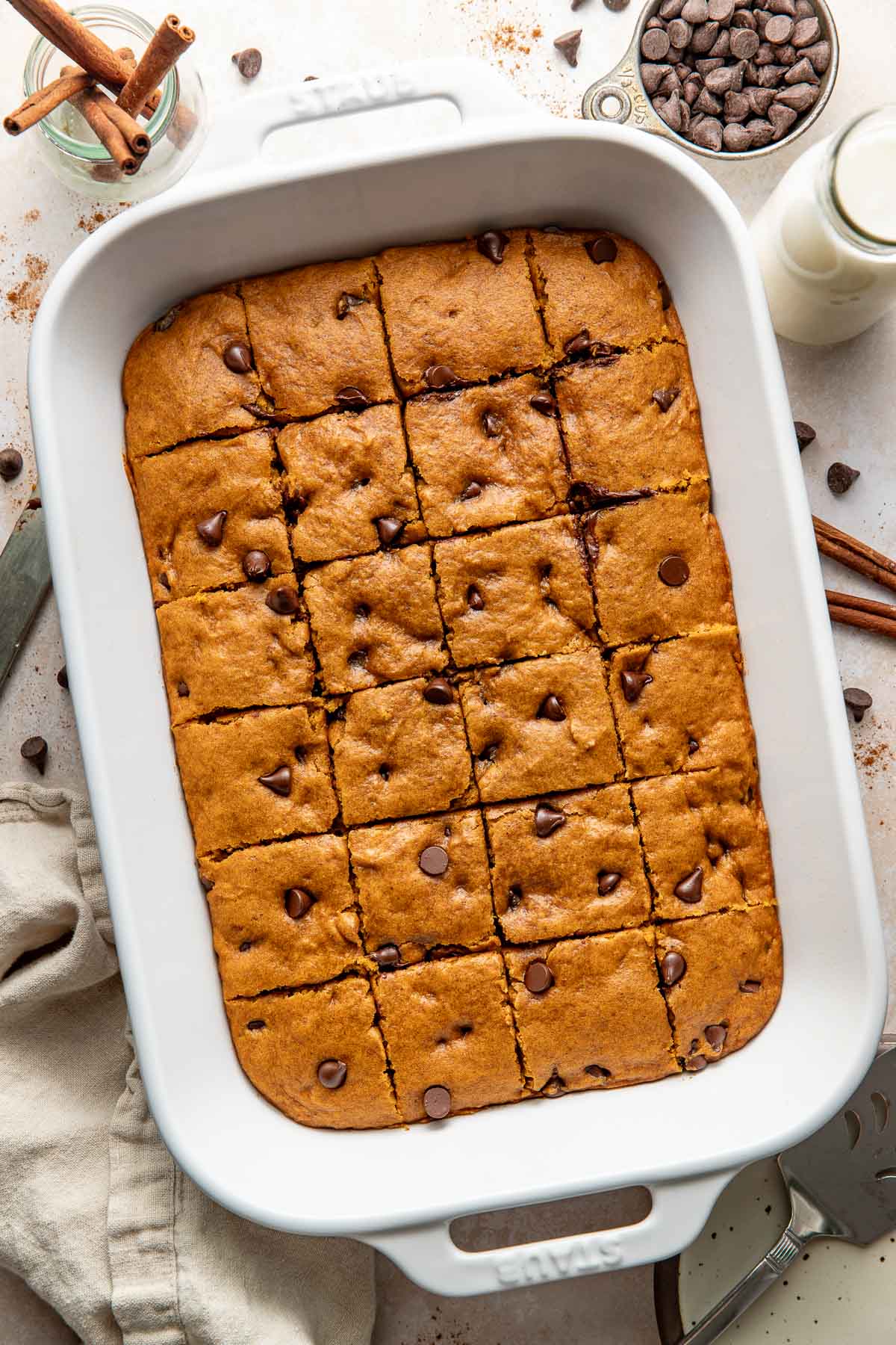Baked pumpkin chocolate chip bars sliced in a baking dish.