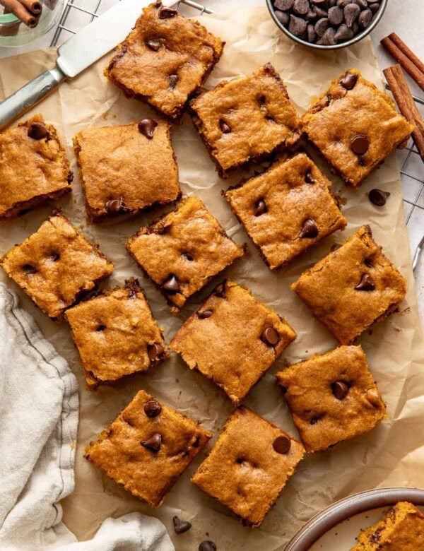 Pumpkin chocolate chip bars on a sheet of parchment paper.