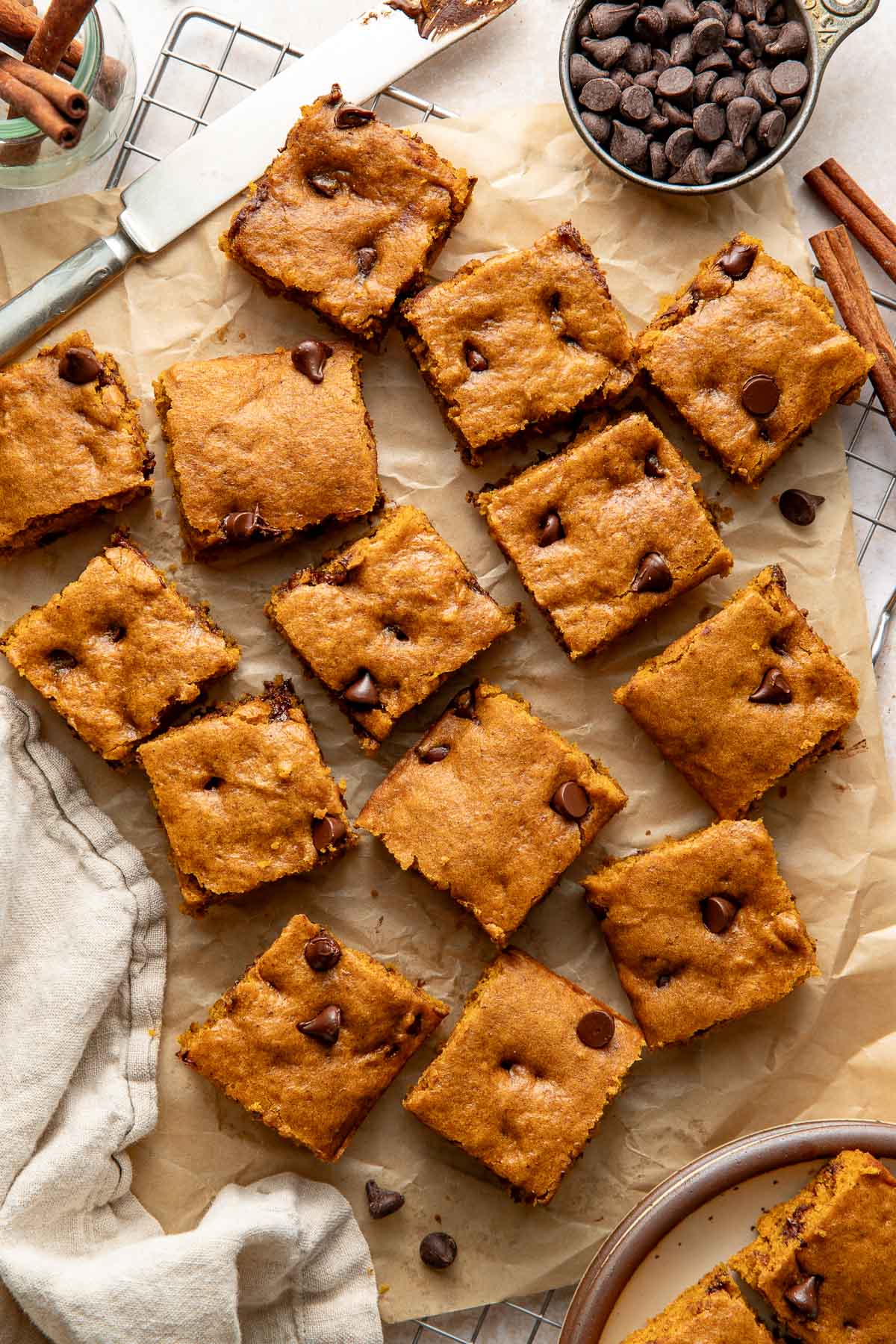 Pumpkin chocolate chip bars on a sheet of parchment paper.