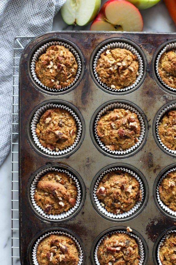 Overhead view of a pan of Paleo Morning Glory Muffins sitting on a wire rack. 