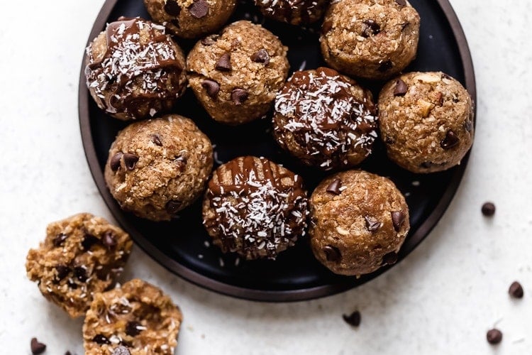 Overhead view almond joy protein bites coated in dark chocolate and coconut shreds