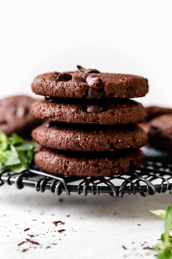 A stack of four Low Sugar Double Chocolate Mint Cookies on a wire cooling rack ready to be enjoyed!