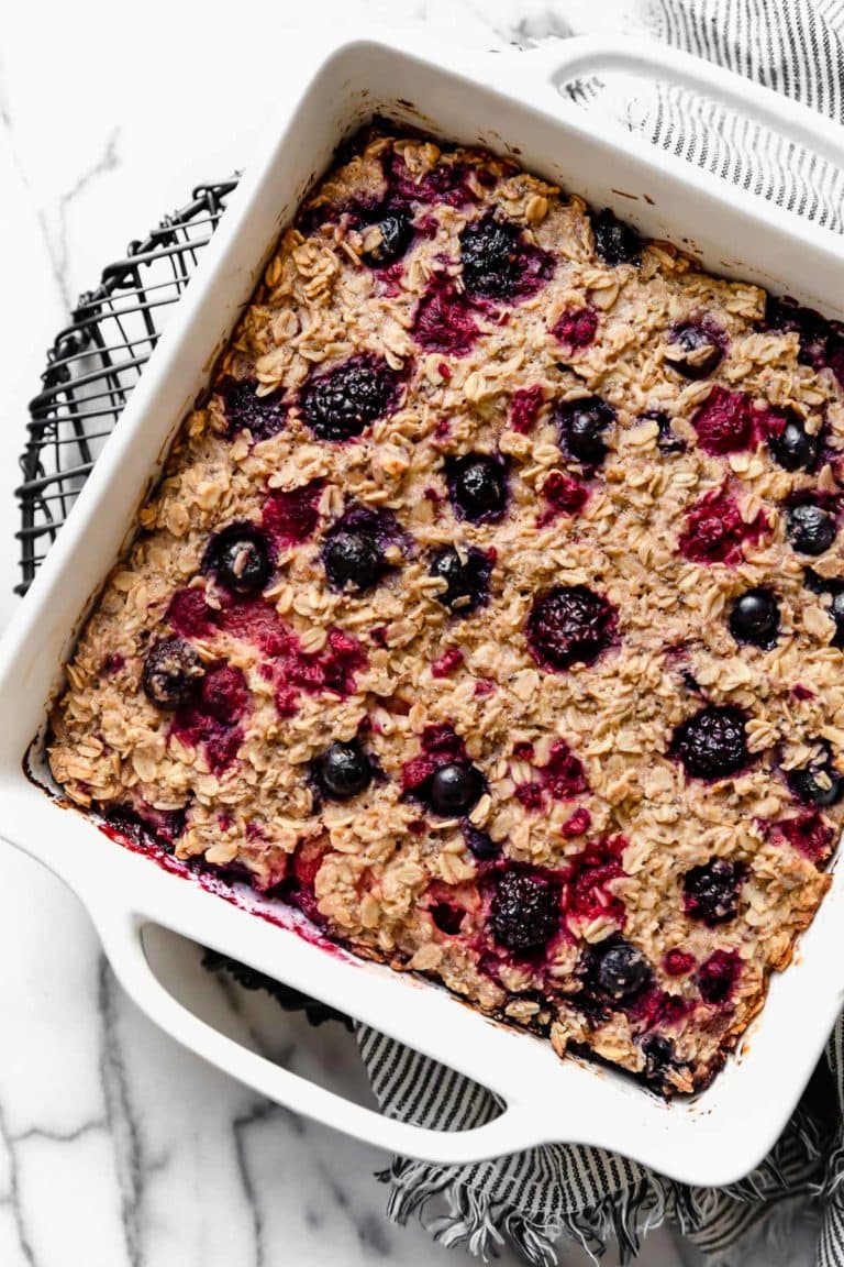 Overhead view mixed berry baked oatmeal in white baking dish