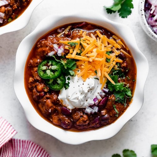 Overhead view slow cooker beef and bean chili in white bowl