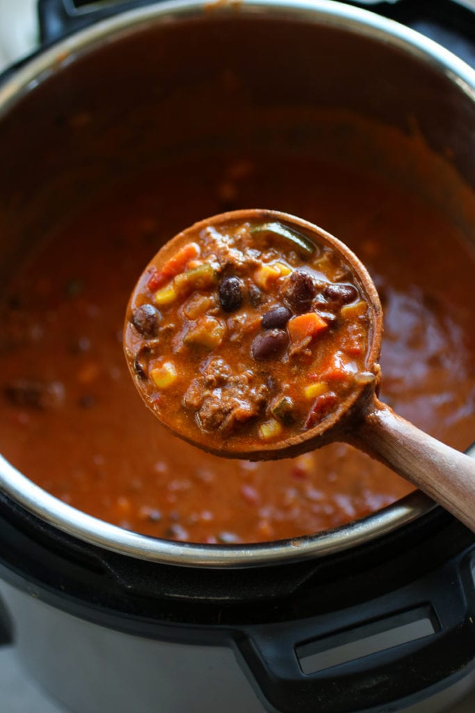 Photo of wooden ladle holding Instant Pot Taco Soup