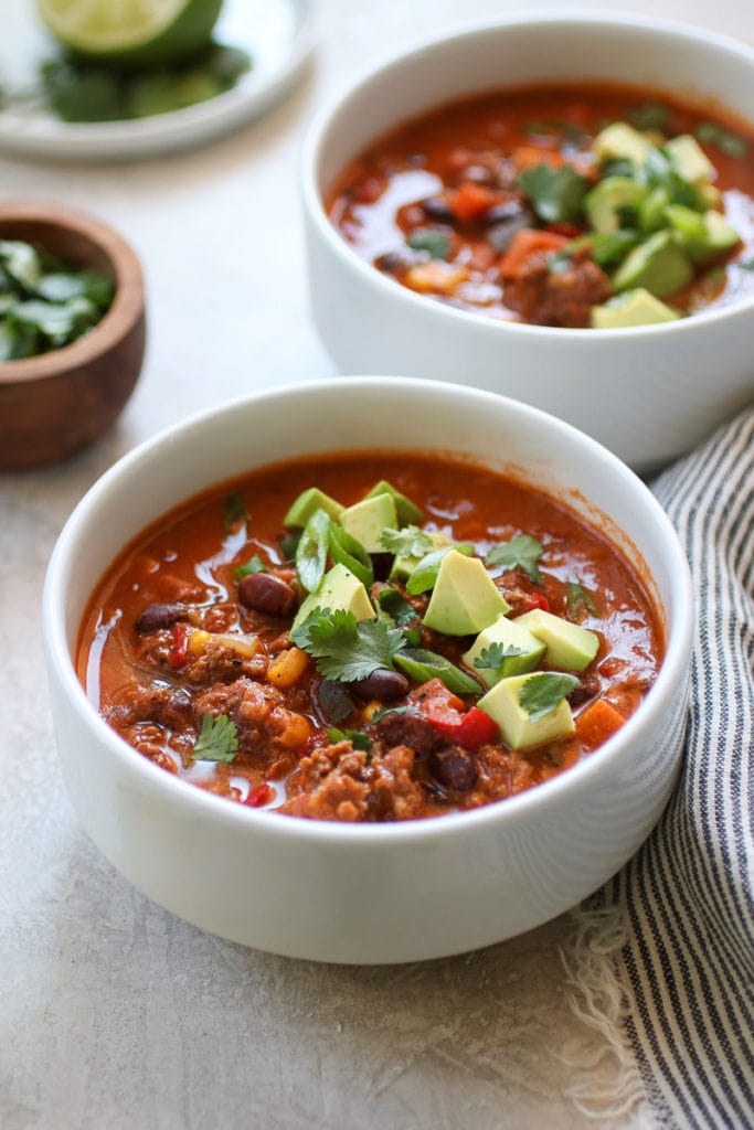 Bowl of Taco Soup topped with cilantro, green onion and avocado