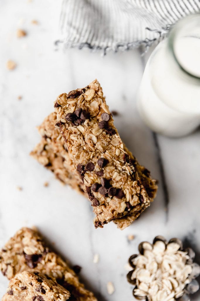 Overhead view healthy granola bars with chocolate chips stacked up on each other