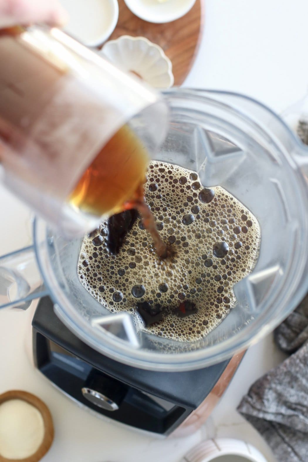 Coffee being poured into a blender for Cinnamon Coconut Lattes. 