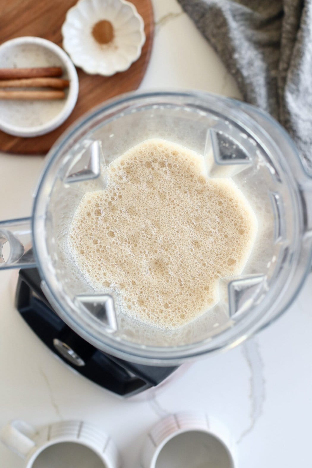 Overhead view of a blender filled with frothy freshly blended Cinnamon Coconut Latte. 