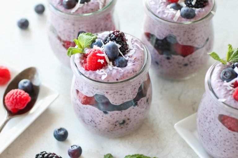 Close up view of Mixed Berry Protein Chia Pudding topped with fresh berries and coconut shreds. 