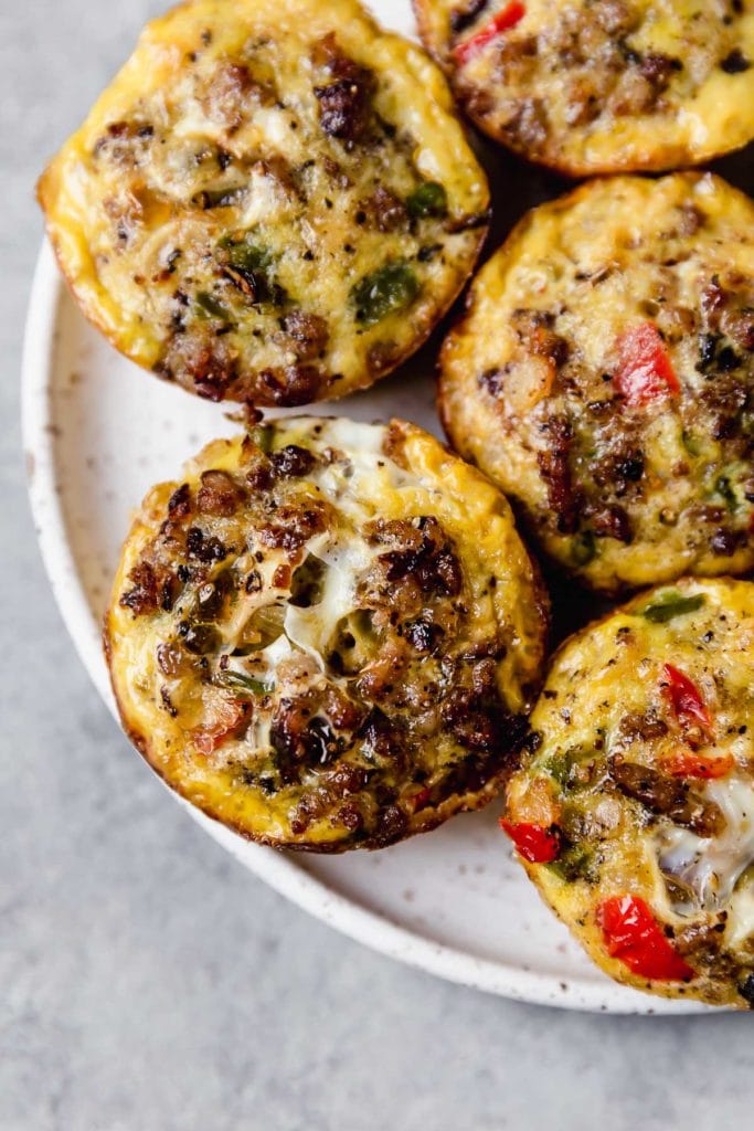 Overhead photo of Sausage Hash Brown Egg Muffins on a white plate. 