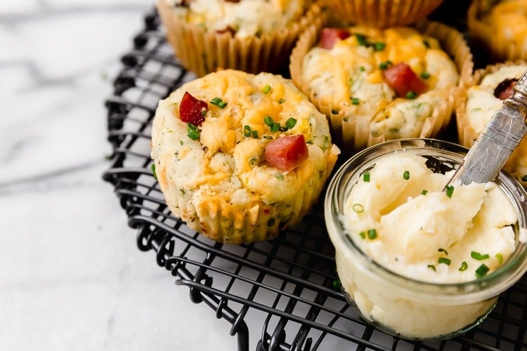 Savory ham and cheese muffins on black cooling rack.