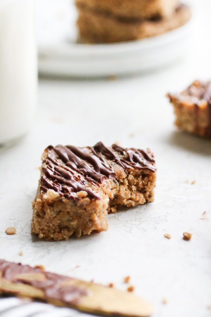 Photo of one of the No-Bake Peanut Butter Crunch Bars with a bite out of it.