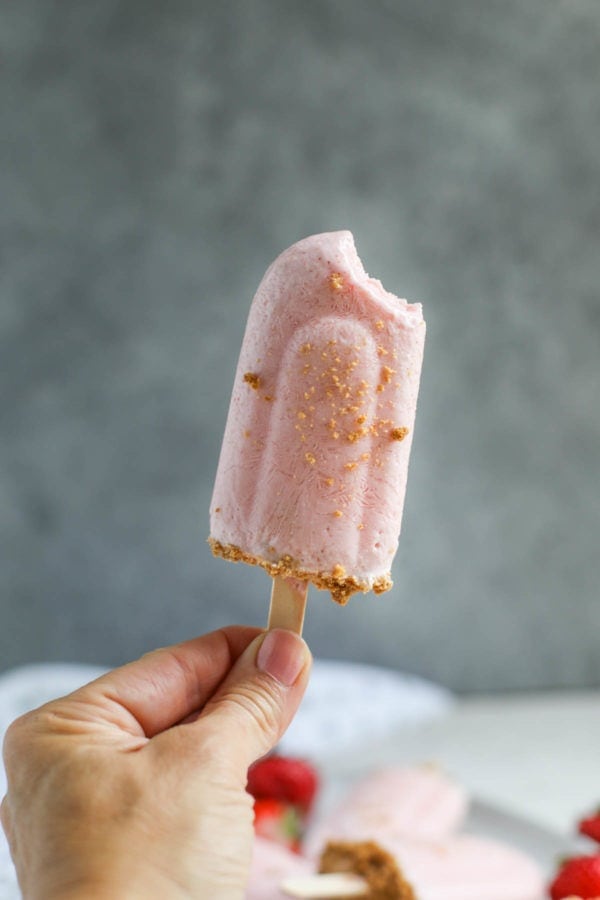 Strawberry Cheesecake Smoothie Pops With a Bite Taken Out