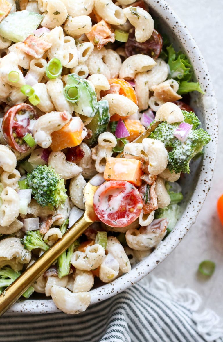 Close up view of a serving bowl filled with creamy ranch pasta salad.