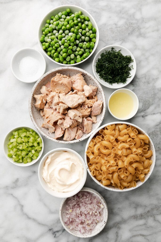 Al ingredients for tuna pasta salad arranged in bowls