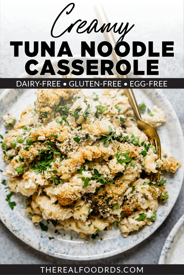 Creamy tuna noodle casserole with breadcrumb topping on a speckles plate with a gold fork on the side