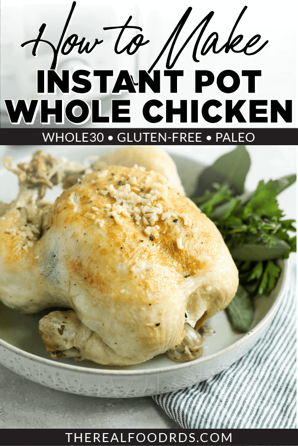 A roasted Instant Pot Whole Chicken in a cream speckled bowl with fresh herbs on the side.