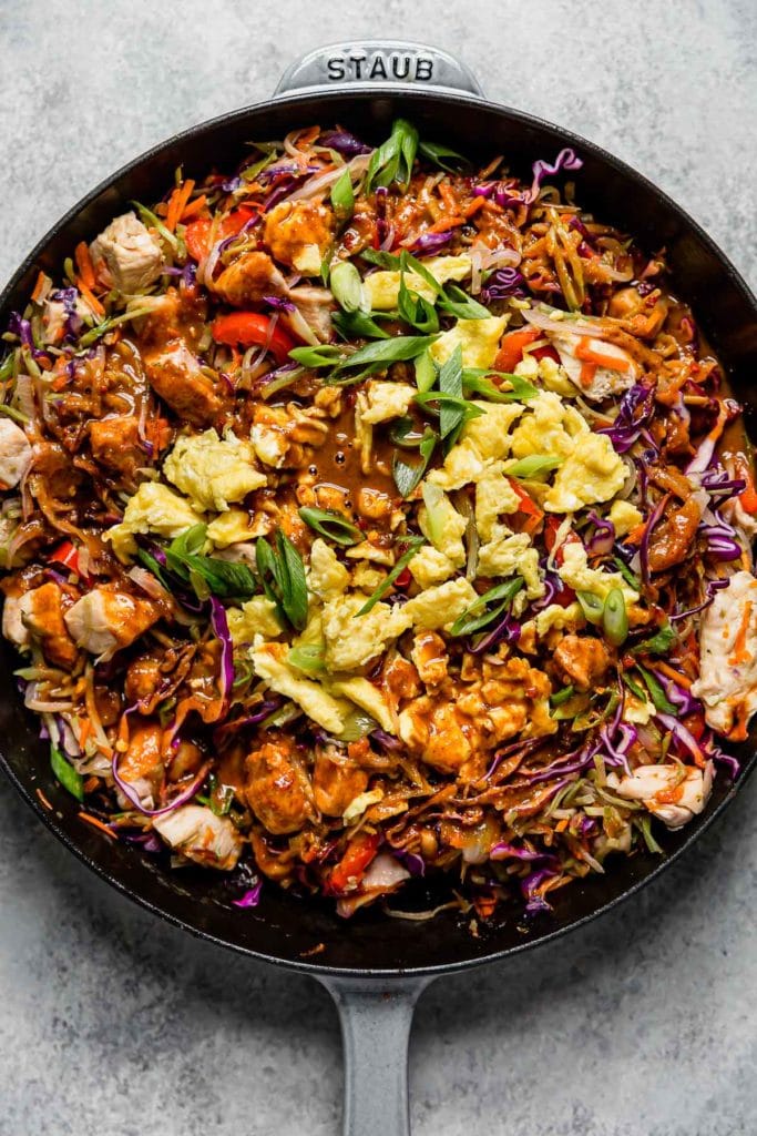 Healthy Chicken Pad Thai in a large cast iron skillet before tossing everything together. 