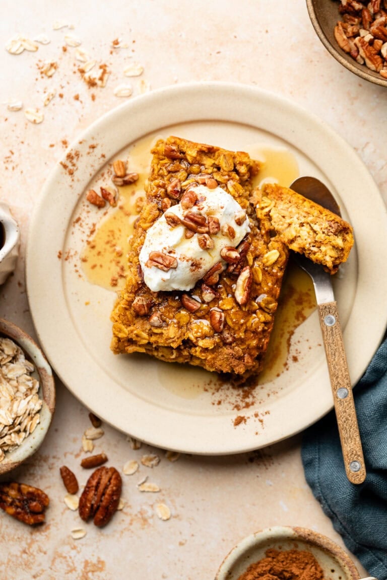 Overhead view pumpkin baked oatmeal on a plate topped with Greek yogurt